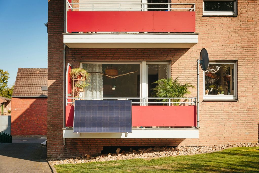 Red balcony screens on brick apartment building